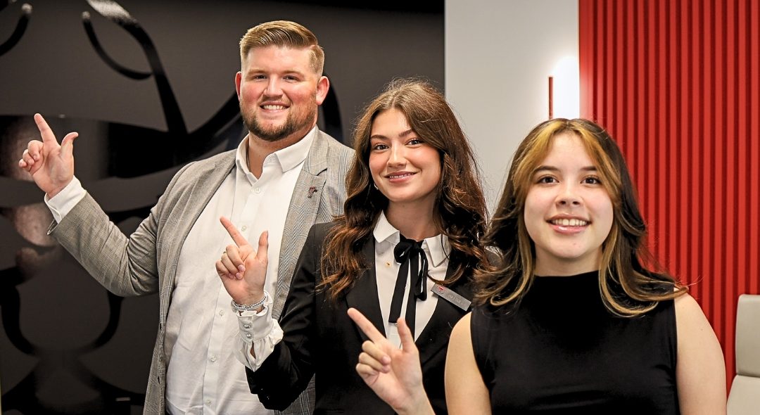 Texas Tech Credit Union interns giving the Guns Up sign