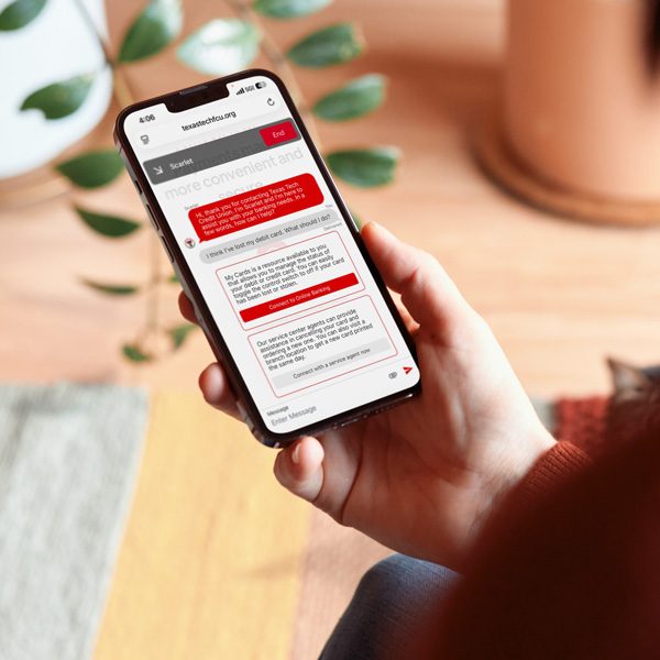Member holding a phone with a Scarlet chat open
