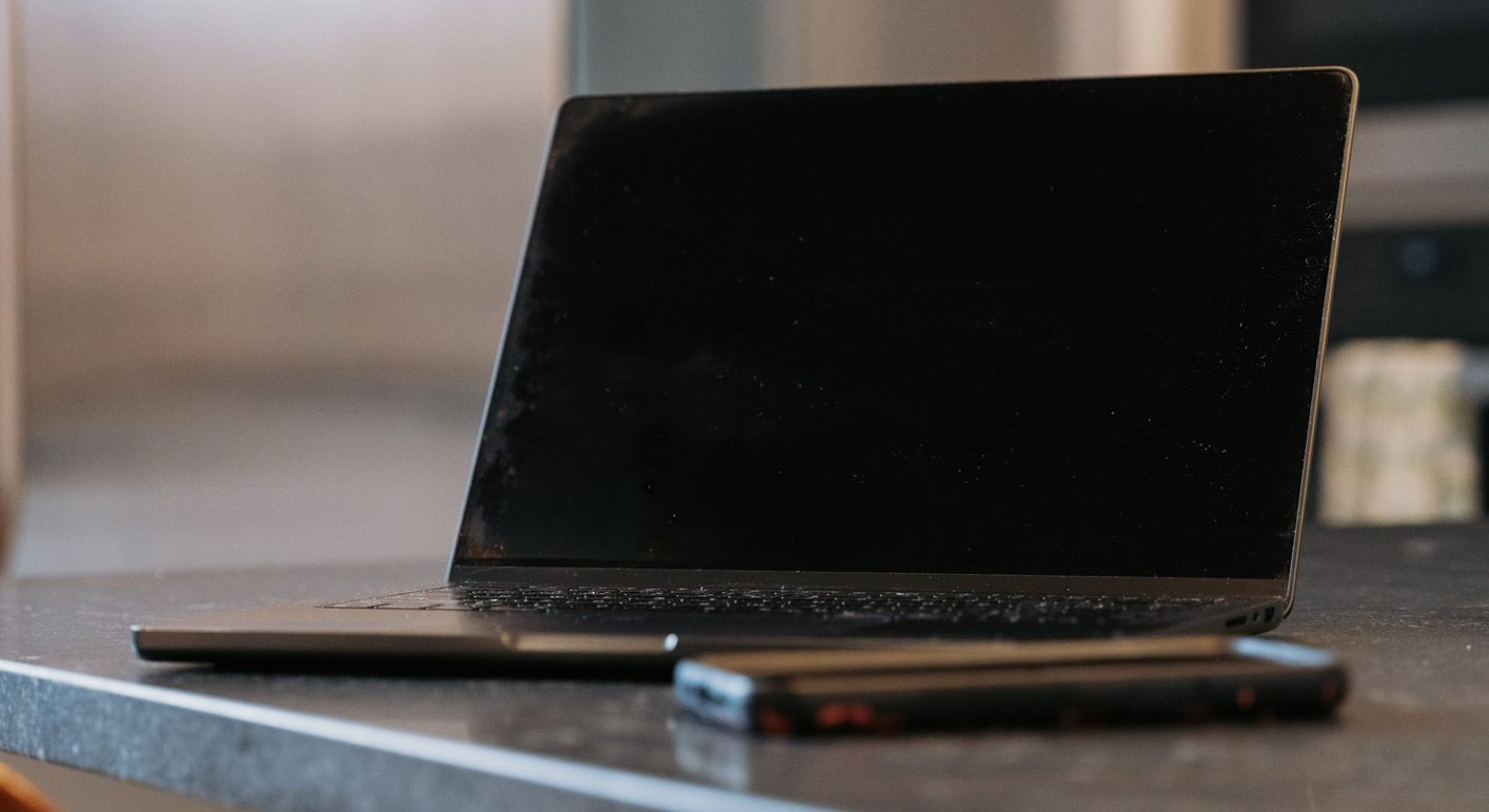A laptop and phone on a desk