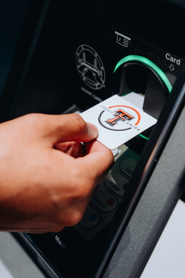 Hand using a Texas Tech debit card