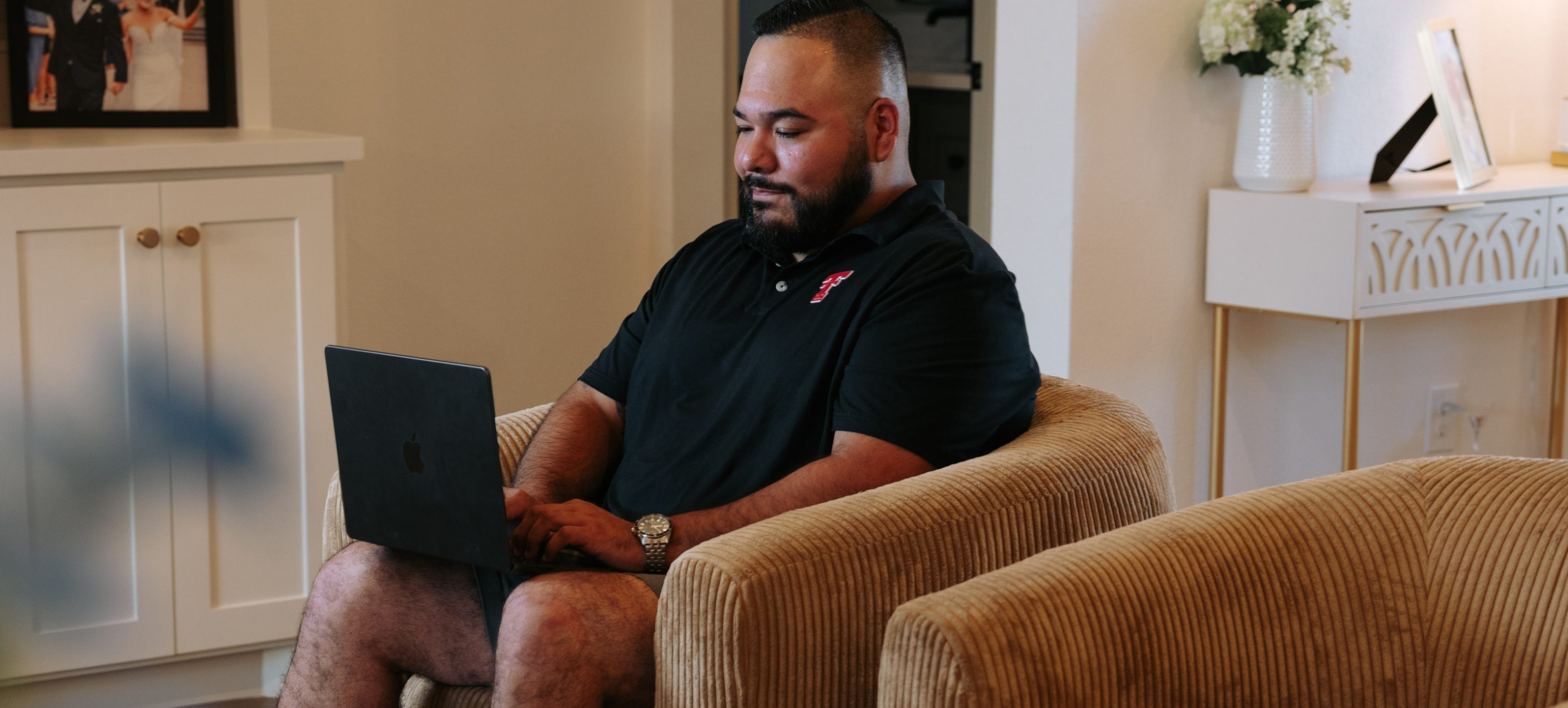 Texas Tech Credit Union member paying bills on a laptop at home