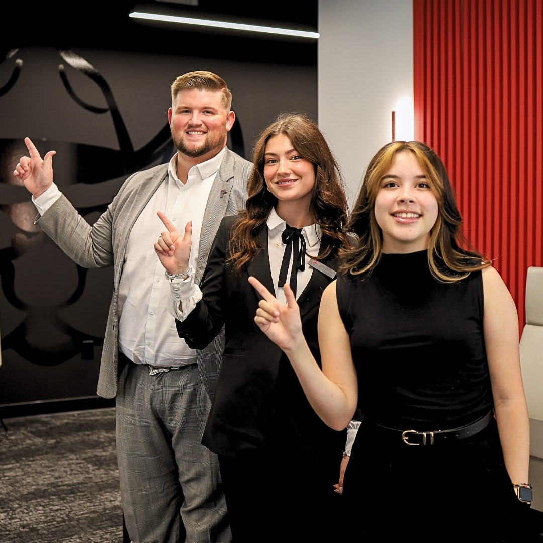 Texas Tech Credit Union interns giving the Guns Up sign