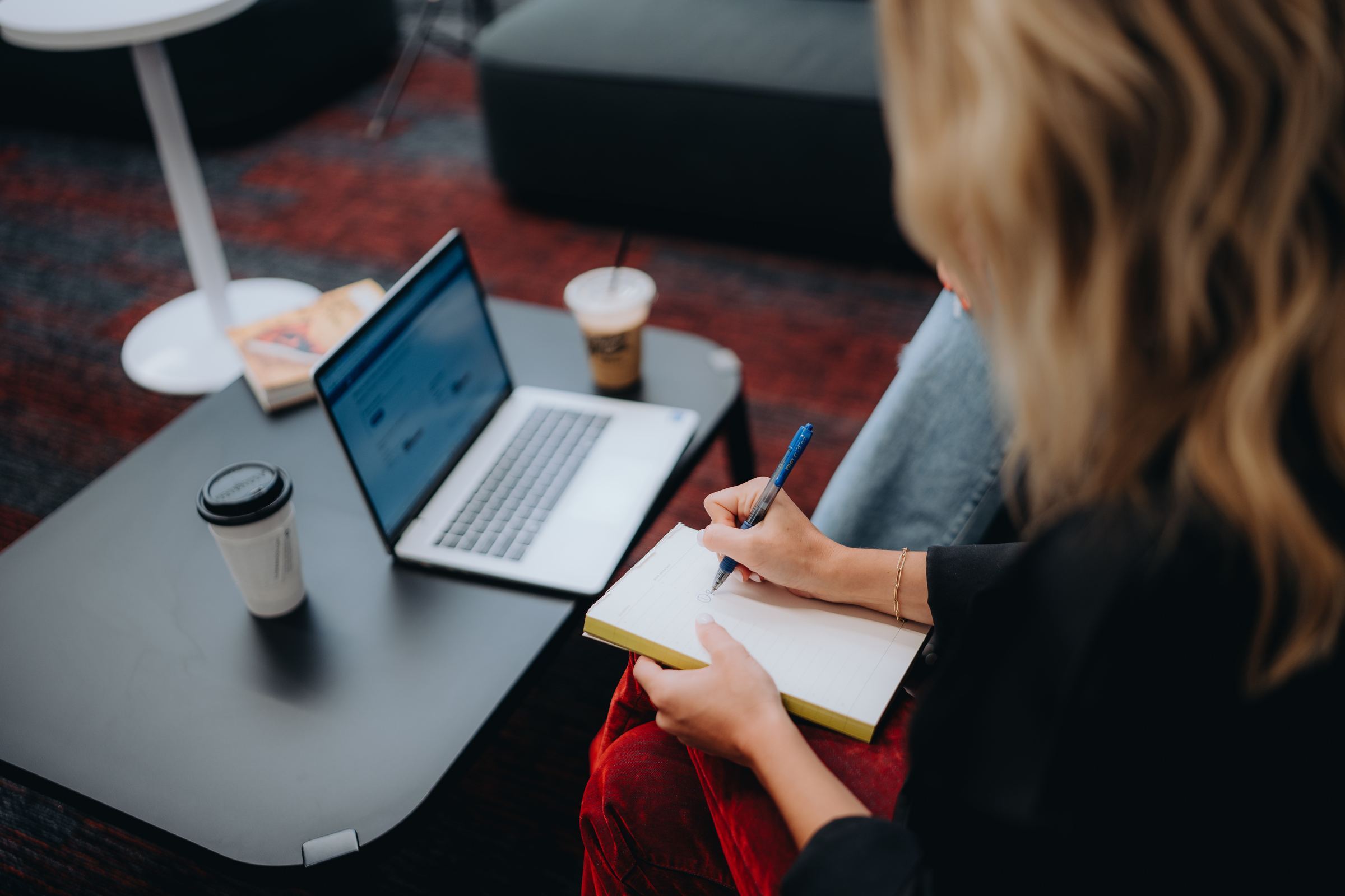 Member planning her budget with a laptop and notebook