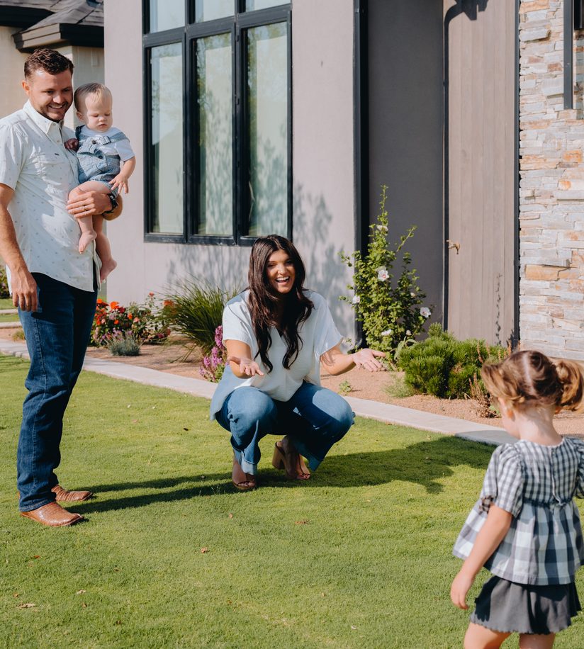 A family outside their refinanced home